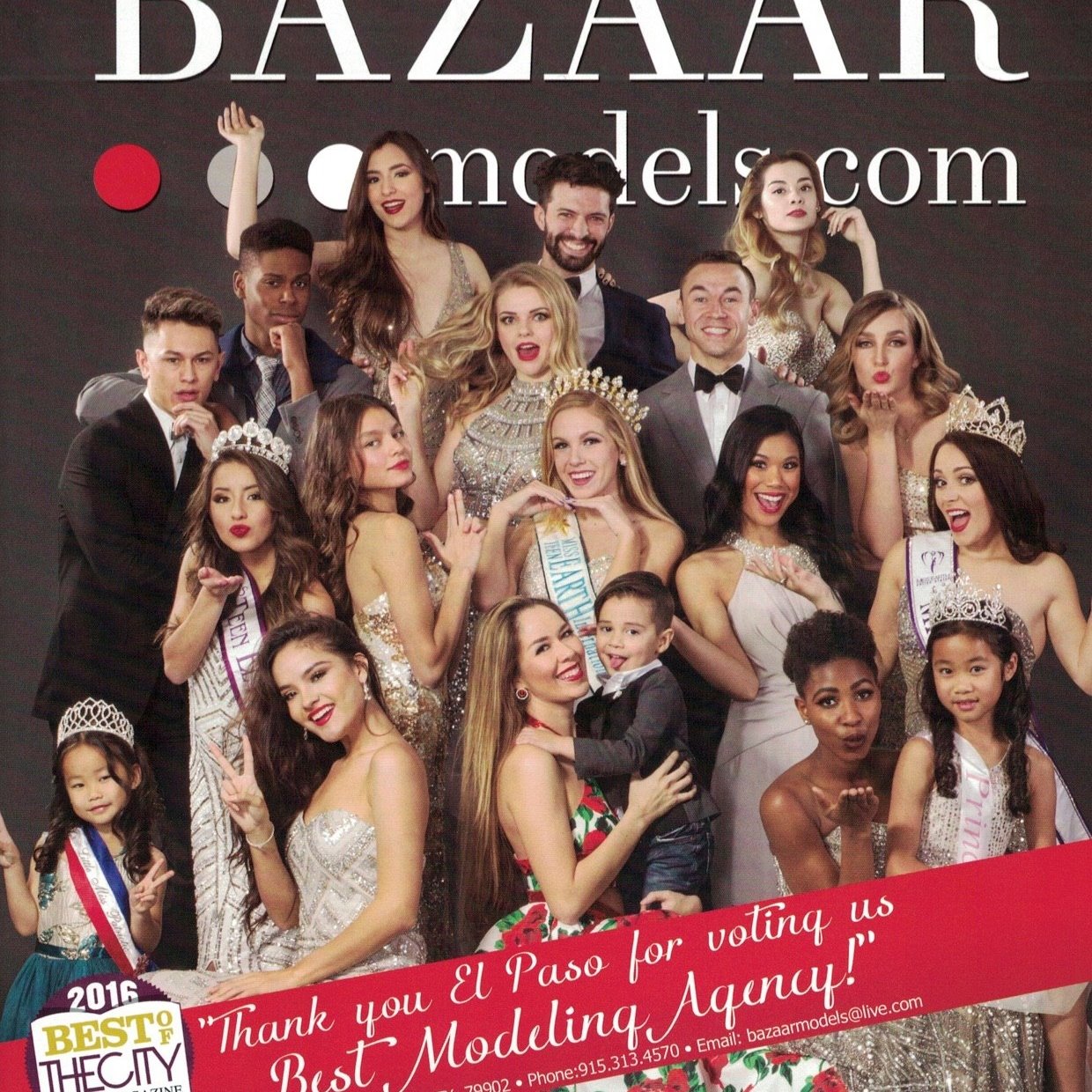 Bazaar Models, Group of people in formal attire posing for a photo, with some holding trophies and wearing crowns. The backdrop features "Bazaarmodels.com" and there are children among the adults.